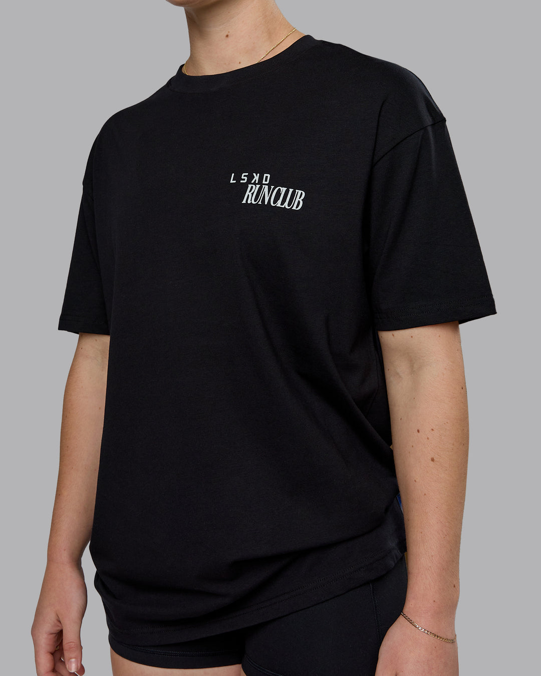 Woman wearing Run Love FLXCotton Oversized Tee - Black-Reflective | Model:Sav | Size:XS