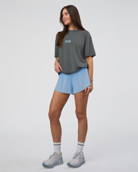 Woman wearing Runner's FLXCotton Oversized Tee - Dark Storm Washed-Open Air | Model:Estella | Size:XS