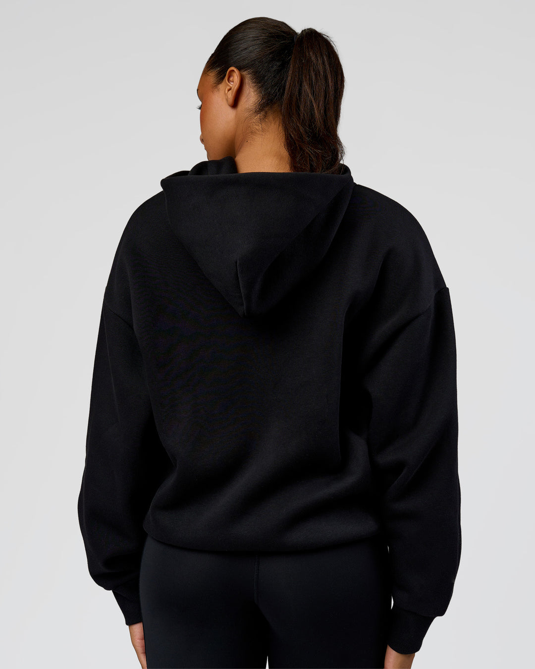 Woman wearing Shadow Mode Oversized Zip Through Hoodie - Black | Model:Rosie | Size:XS