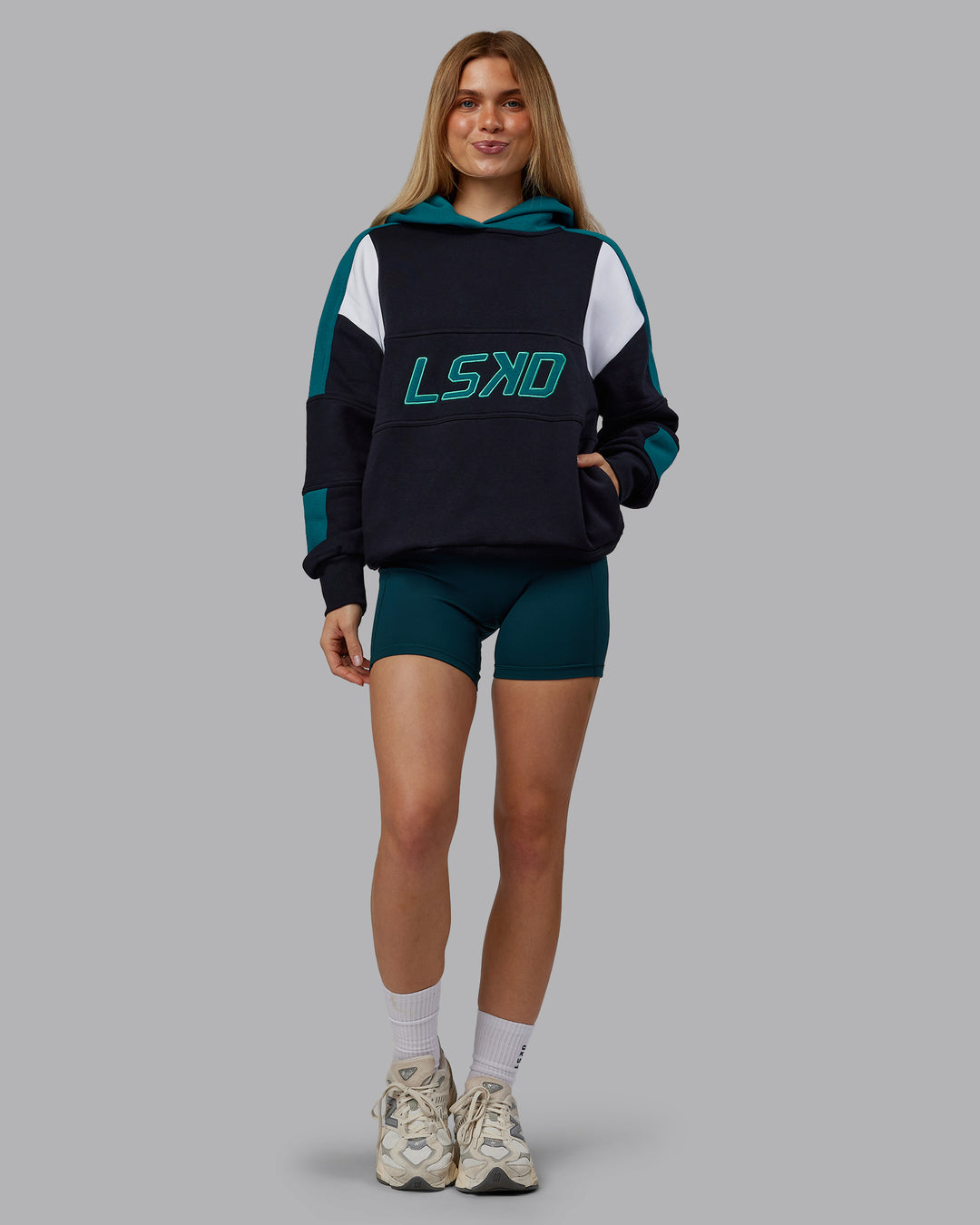 Woman wearing Slam Oversized Hoodie - Caviar-Blue Coral | Model:Emilie | Size:XS