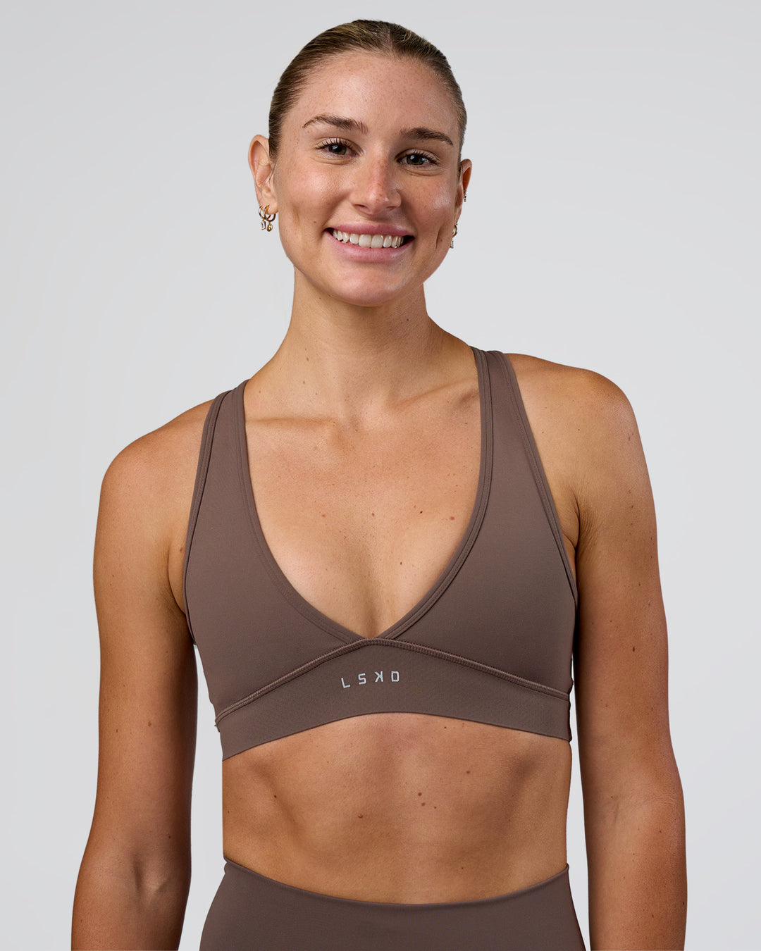 Woman wearing Stamina Sports Bra - Peppercorn | Model:Emelia | Size:XS