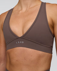 Woman wearing Stamina Sports Bra - Peppercorn | Set:true | Angle:closeup | Model:Emelia | Size:XS