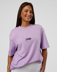 Woman wearing Standard Issue FLXCotton Oversized Tee - Pale Lilac-Black | Model:Bianca | Size:XS