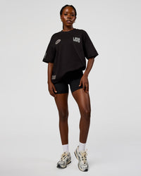 Woman wearing Static Grit Heavyweight Oversized Tee - Black-Alloy | Model:Ellie | Size:XS