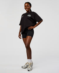 Woman wearing Static Grit Heavyweight Oversized Tee - Black-Alloy | Model:Ellie | Size:XS