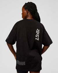 Woman wearing Static Grit Heavyweight Oversized Tee - Black-Alloy | Model:Ellie | Size:XS