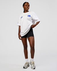 Woman wearing Static Grit Heavyweight Oversized Tee - White-Electric Indigo | Model:Ellie | Size:XS