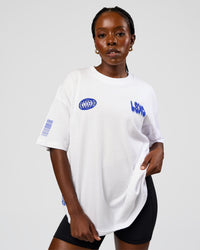 Woman wearing Static Grit Heavyweight Oversized Tee - White-Electric Indigo | Model:Ellie | Size:XS