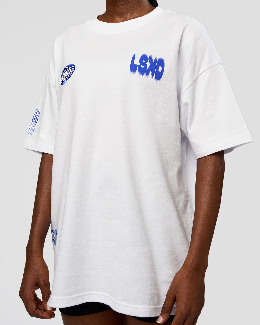 Woman wearing Static Grit Heavyweight Oversized Tee - White-Electric Indigo | Model:Ellie | Size:XS