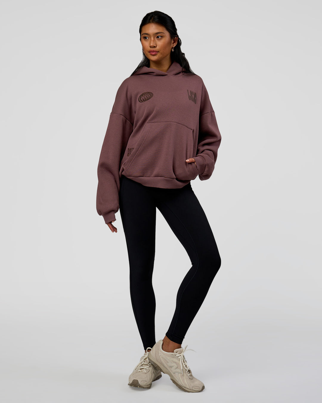 Woman wearing Static Grit Unisex Boxy Hoodie - Cocoa Powder-Hot Chocolate | Model:Loren | Size:XS