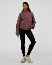 Woman wearing Static Grit Unisex Boxy Hoodie - Cocoa Powder-Hot Chocolate | Model:Loren | Size:XS