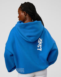 Woman wearing Static Grit Unisex Boxy Hoodie - Palace Blue-White | Model:Ellie | Size:XS