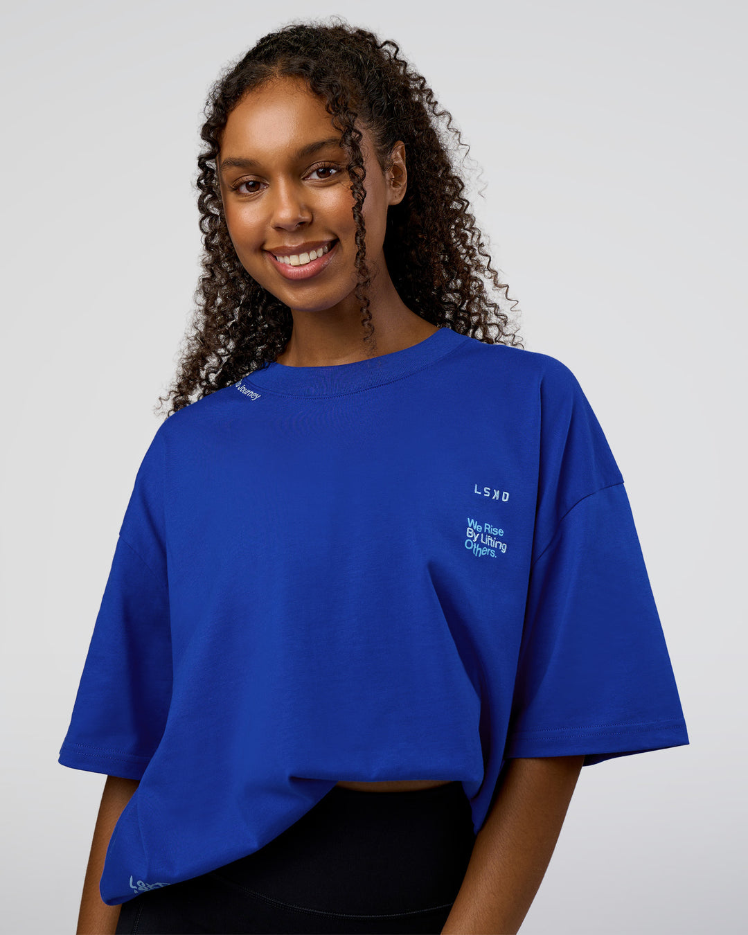 Woman wearing Sticker Heavyweight Oversized Tee - Electric Indigo-Baltic Sea | Model:Jordan | Size:XS