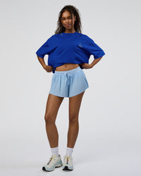 Woman wearing Sticker Heavyweight Oversized Tee - Electric Indigo-Baltic Sea | Model:Jordan | Size:XS