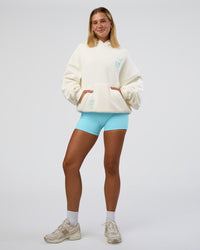 Woman wearing Sticker Unisex Oversized Hoodie - Off White-Jelly Mint | Model:Amity | Size:XS