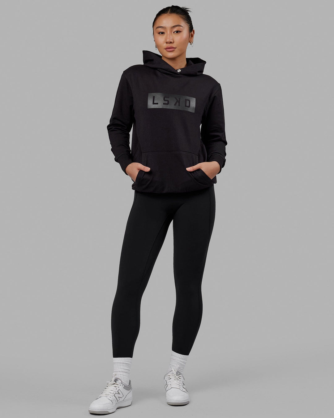 Woman wearing Unisex Strength FLXFLeece Hoodie - Black-Black