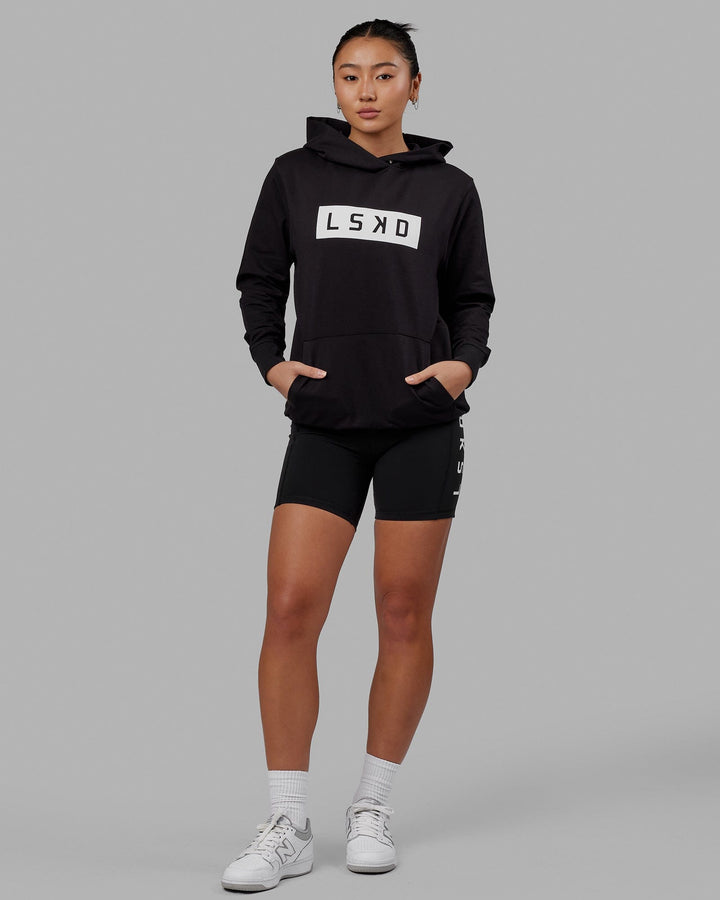 Woman wearing Unisex Strength FLXFLeece Hoodie - Black-White