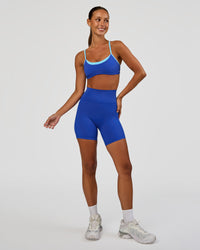 Woman wearing Tempo Sports Bra - Electric Indigo-Baltic Sea | Model:Brylee | Size:XS