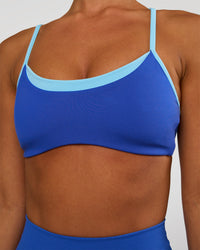Woman wearing Tempo Sports Bra - Electric Indigo-Baltic Sea | Model:Brylee | Size:XS