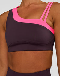 Woman wearing Thrive Asymmetric Sports Bra - Midnight Plum-Sugar Plum | Model:Brylee | Size:XS