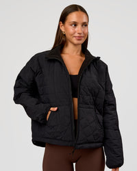 Woman wearing Thrive Reversible Jacket - Black | Model:Brylee | Size:XS