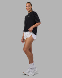 Woman wearing Today's Run FLXCotton Oversized Tee - Black-White | Model:Charlize | Size:XS