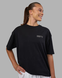 Woman wearing Today's Run FLXCotton Oversized Tee - Black-White | Model:Charlize | Size:XS