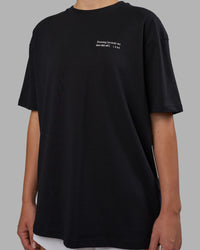 Woman wearing Today's Run FLXCotton Oversized Tee - Black-White | Model:Charlize | Size:XS