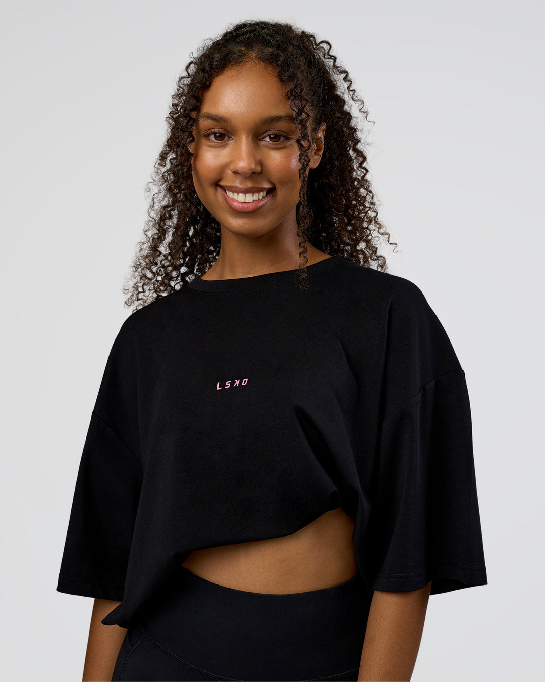 Woman wearing Together We Rise FLXCotton Oversized Tee - Black-Candy Pink | Model:Jordan | Size:L