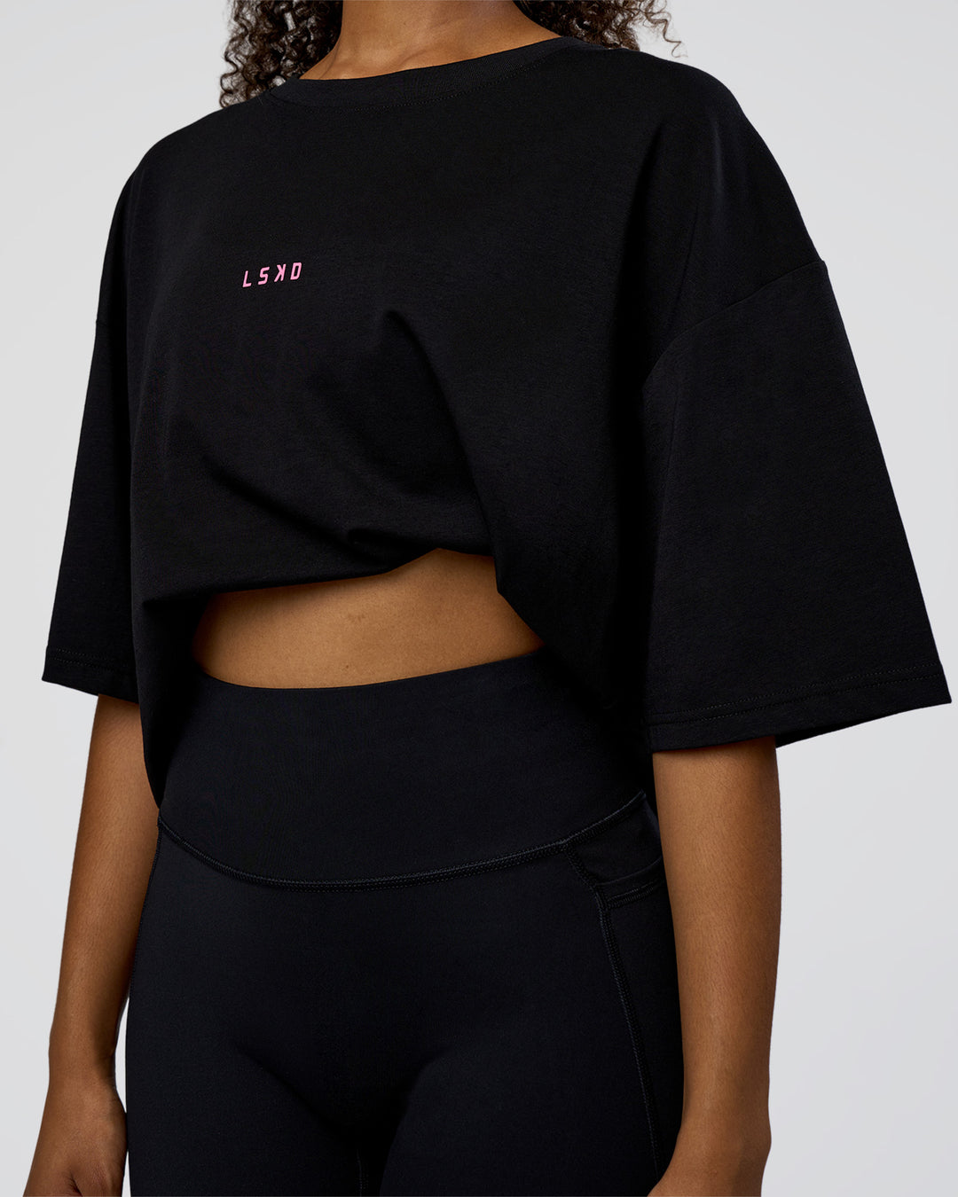 Woman wearing Together We Rise FLXCotton Oversized Tee - Black-Candy Pink | Model:Jordan | Size:L