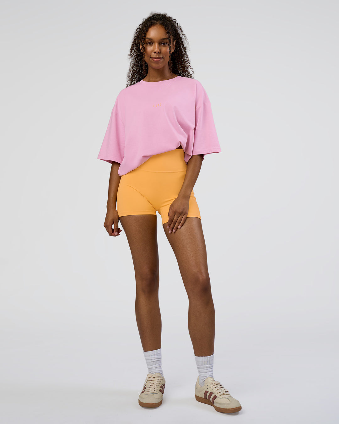 Woman wearing Together We Rise FLXCotton Oversized Tee - Bubblegum-Warm Apricot | Model:Jordan | Size:L