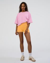 Woman wearing Together We Rise FLXCotton Oversized Tee - Bubblegum-Warm Apricot | Model:Jordan | Size:L
