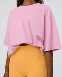 Woman wearing Together We Rise FLXCotton Oversized Tee - Bubblegum-Warm Apricot | Model:Jordan | Size:L