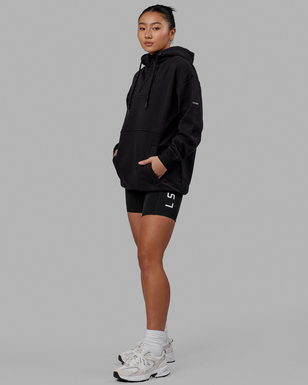 Woman wearing Unisex Trek Hoodie Oversize - Black