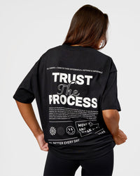 Woman wearing Trust The Process Heavyweight Unisex Oversized Tee - Black-White | Model:Kirstyn | Size:XS