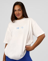 Woman wearing Trust The Process Heavyweight Unisex Oversized Tee - Off White-Electric Indigo | Model:Kirstyn | Size:XS