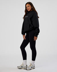Woman wearing Trust The Process Unisex Oversized Hoodie - Black-White | Model:Kirstyn | Size:XS