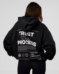 Woman wearing Trust The Process Unisex Oversized Hoodie - Black-White | Model:Kirstyn | Size:XS