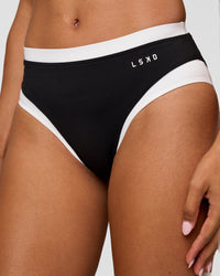 Woman wearing Turbo Track Brief in Black-White| Model:Txai | Size:XS