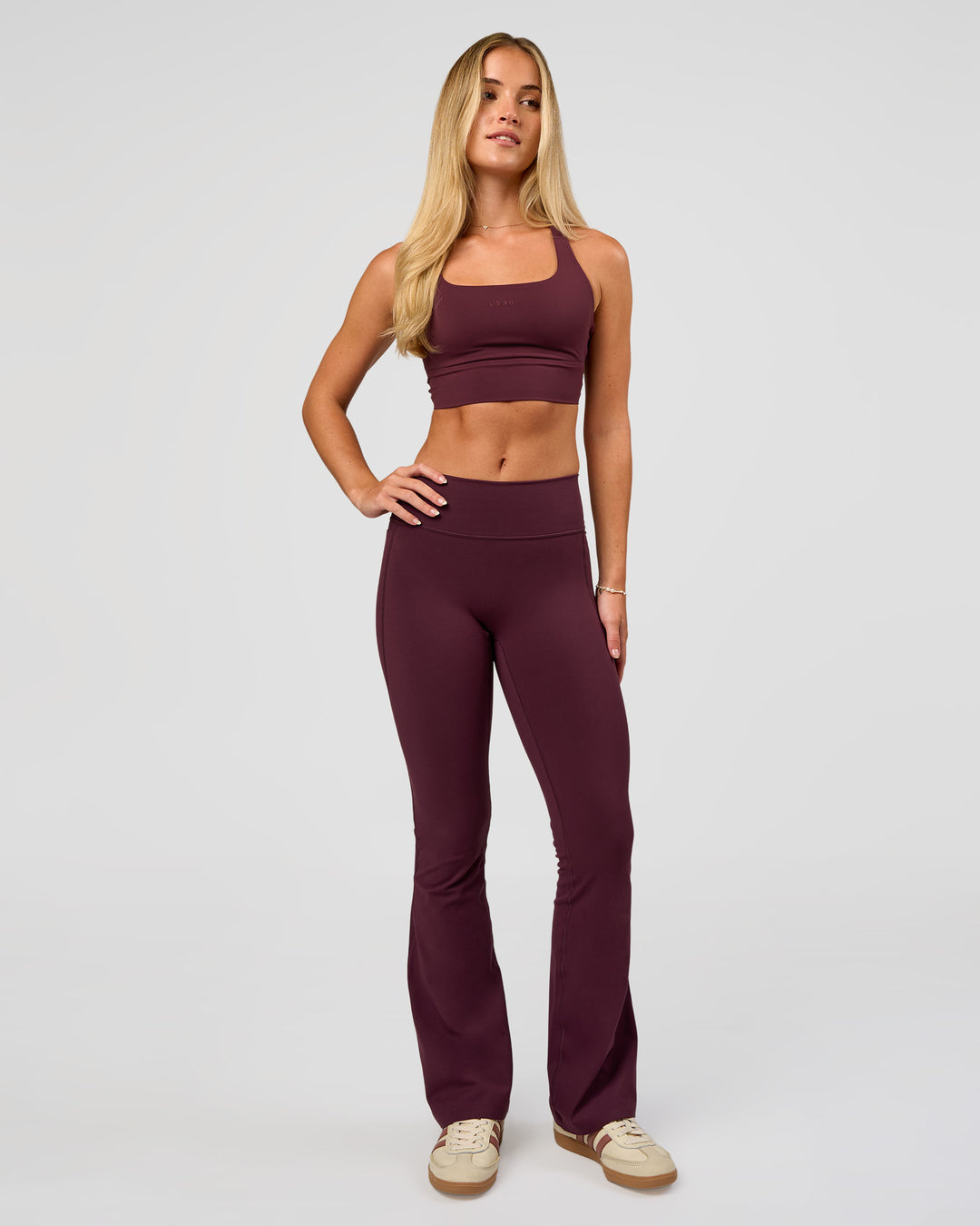 Woman wearing Twist Long Line Sports Bra in Cherry Lacquer | Model:Issy | Size:XS
