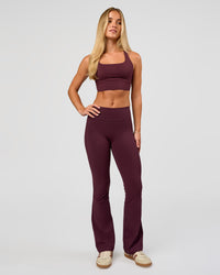 Woman wearing Twist Long Line Sports Bra in Cherry Lacquer | Model:Issy | Size:XS