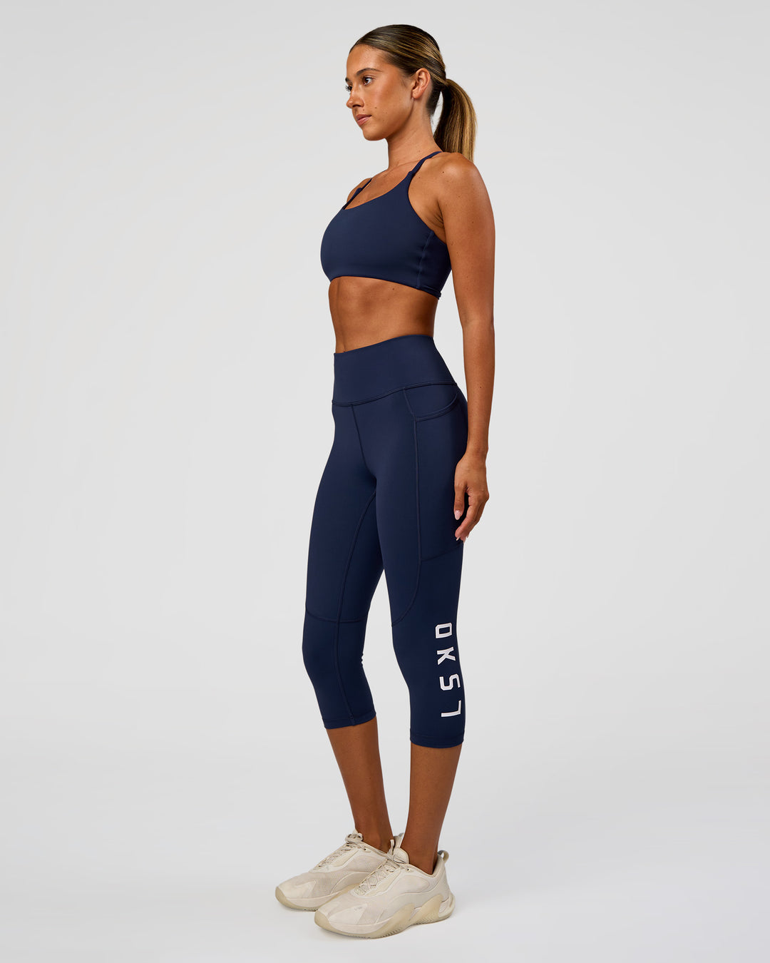 Woman wearing Twist Sports Bra - Future Navy | Model:Charli | Size:XS