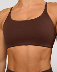 Woman wearing Twist Sports Bra - Hot Chocolate | Model:Maja | Size:XS