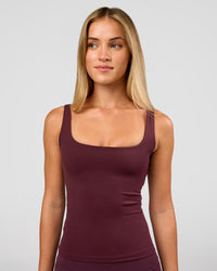 Woman wearing Twist Square Neck Shelf Bra Tank in Cherry Lacquer | Model:Issy | Size:XS