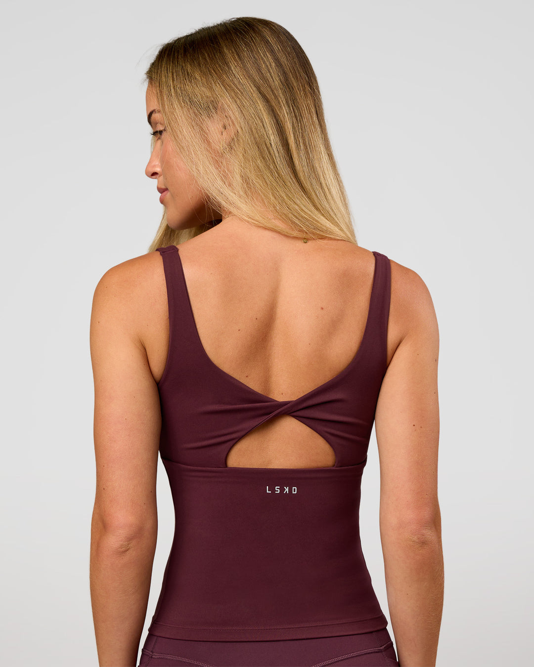 Woman wearing Twist Square Neck Shelf Bra Tank in Cherry Lacquer | Model:Issy | Size:XS