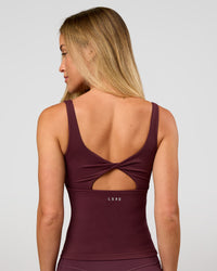 Woman wearing Twist Square Neck Shelf Bra Tank in Cherry Lacquer | Model:Issy | Size:XS