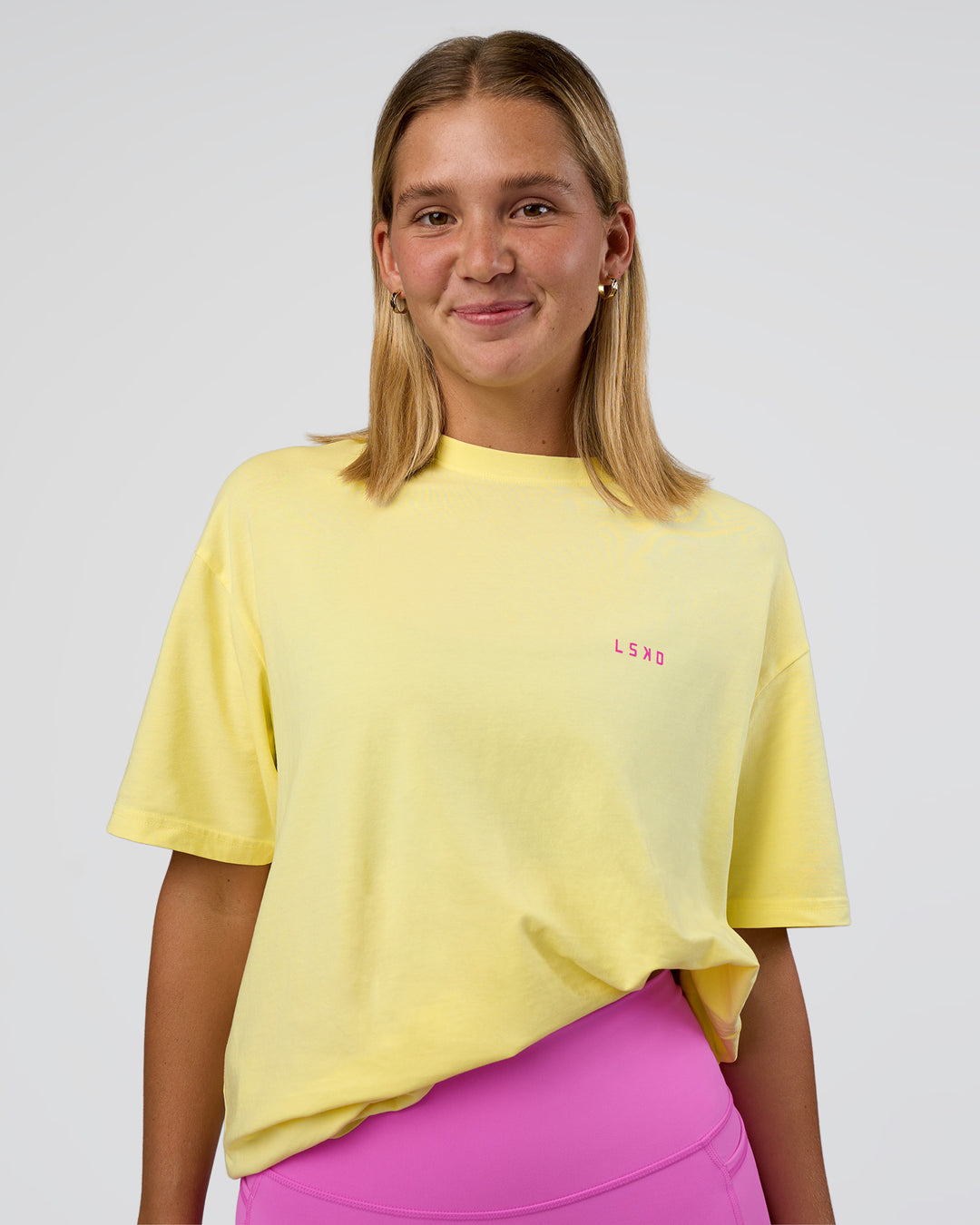 Woman wearing Unfit Club FLXCotton Oversized Tee - Yellow Fizz Washed-Ultra Fuchsia | Model:Amity | Size:XS