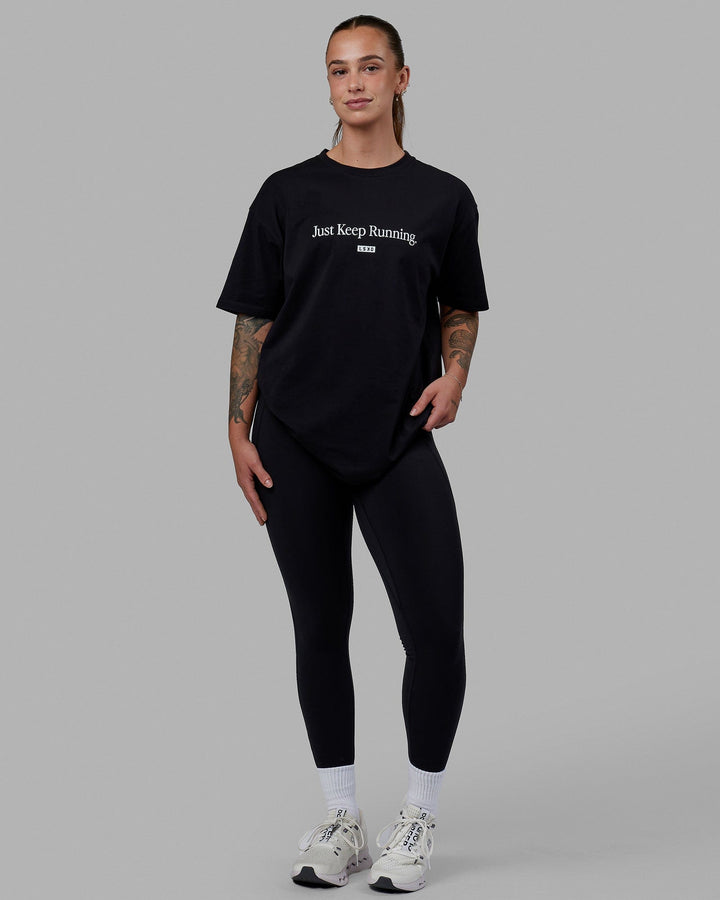 Woman wearing Unisex Just Keep Running FLXCotton Tee Oversize - Black-White