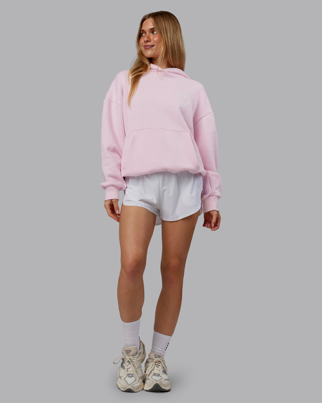 Woman wearing Unisex Love The Process Oversize Hoodie - Petal Pink-White | Model:Emilie | Size:XS