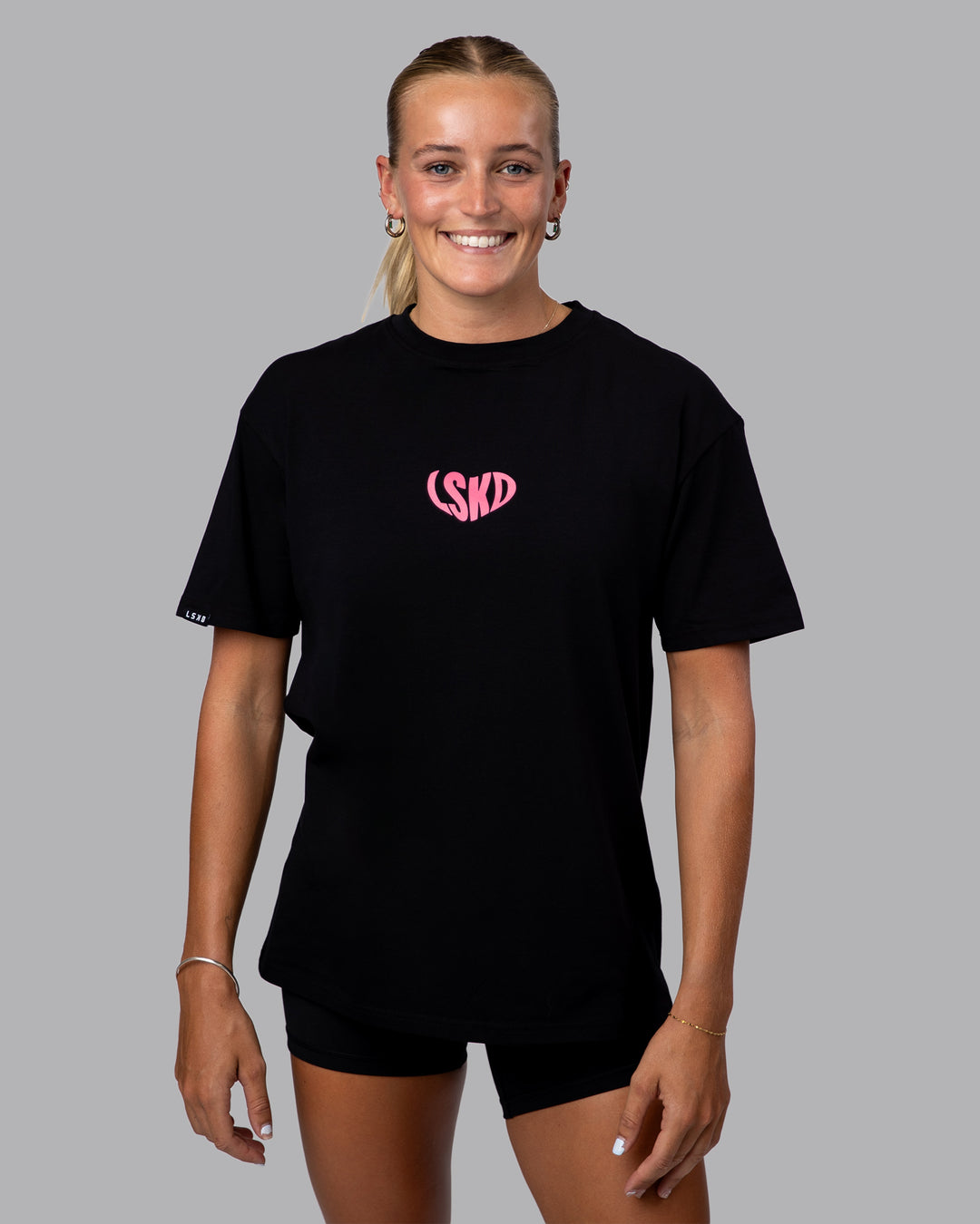 Woman wearing Unisex Love To Train FLXCotton Tee Oversize in Black-Pink Lemonade | Size:XS